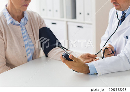 doctor with tonometer and senior woman at hospital doctor with tonometer and senior woman at hospital 40058343