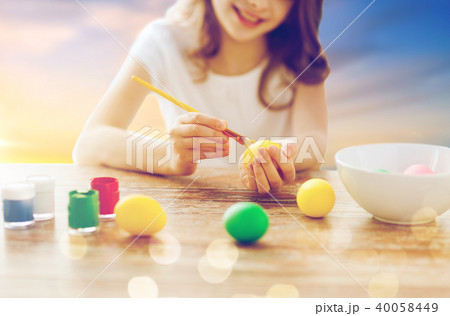 close up of girl coloring easter eggs close up of girl coloring easter eggs 40058449