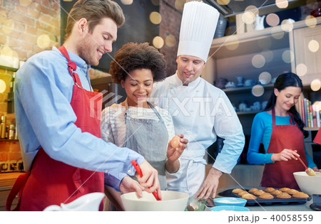 happy friends and chef cook baking in kitchen happy friends and chef cook baking in kitchen 40058559