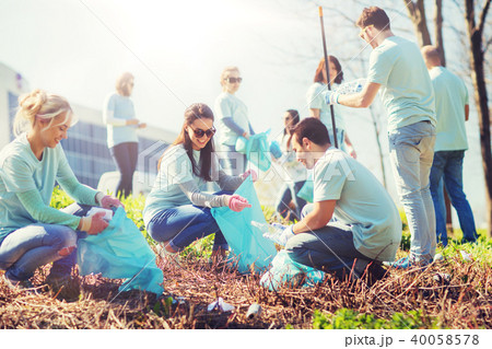 volunteers with garbage bags cleaning park area volunteers with garbage bags cleaning park area 40058578