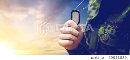 close up of young soldier with military badge 40058889