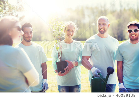 group of volunteers with tree seedling in park group of volunteers with tree seedling in park 40059138