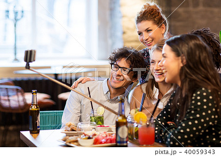 friends taking selfie by smartphone at bar or cafe 40059343