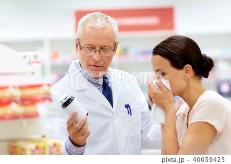 apothecary and sick customer at pharmacy 40059425