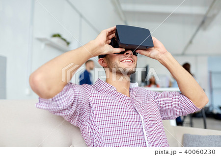 happy man with virtual reality headset at office happy man with virtual reality headset at office 40060230