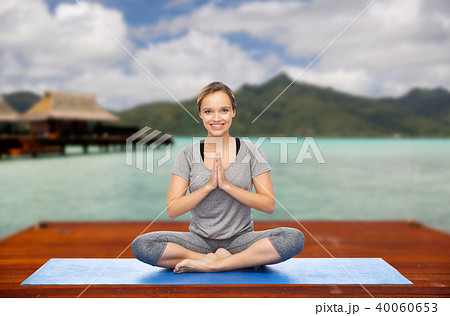 woman making yoga in and meditating lotus pose woman making yoga in and meditating lotus pose 40060653