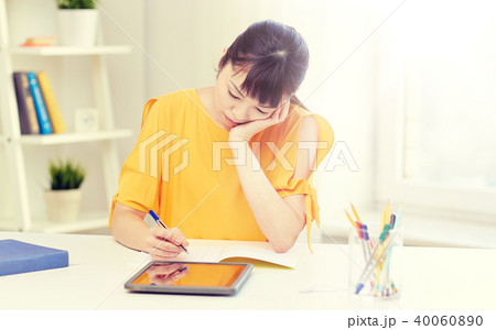 bored asian woman student with tablet pc at home bored asian woman student with tablet pc at home 40060890