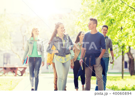 group of happy teenage students walking outdoors 40060894