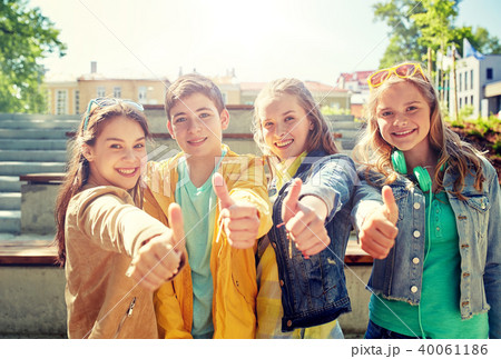 happy students or friends showing thumbs up 40061186