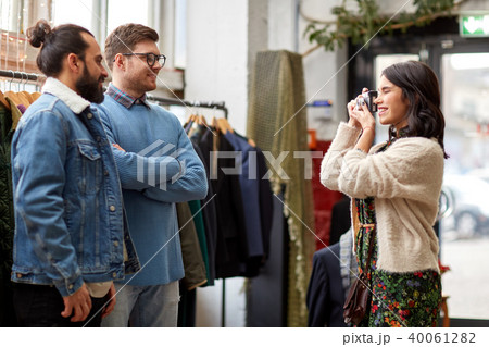friends photographing at vintage clothing store 40061282