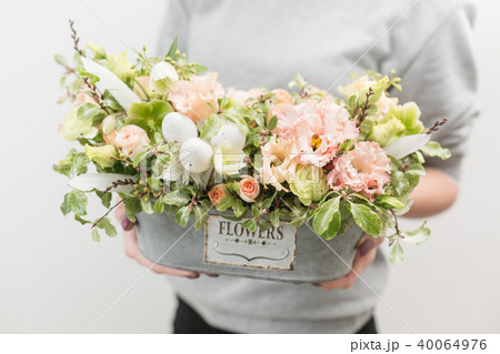flower arrangement. beautiful luxury bouquet of mixed flowers in woman hand. the work of the florist flower arrangement. beautiful luxury bouquet of mixed flowers in woman hand. the work of the florist 40064976