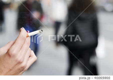 young woman smoking a cigarette 40069860