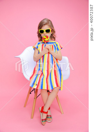 Cute girl in sunglasses with lollipop Cute girl in sunglasses with lollipop 40072387