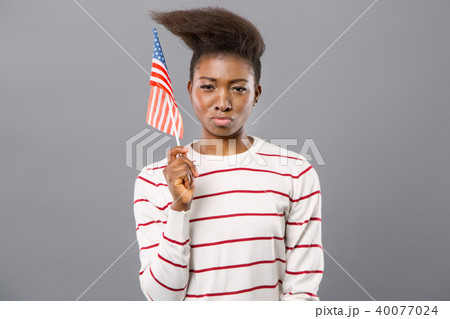 Confident young woman showing American flag 40077024