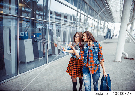 Two young beautiful girls are studying and looking at the map.Ar 40080328