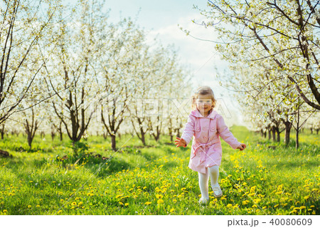 child outdoors in the blossom trees. Art processing and retouchi 40080609