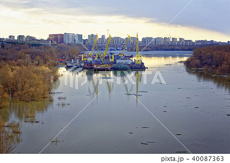Ice drift on the Irtysh river in Siberia. Technical vessels parked in the backwater 40087363