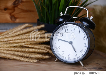 Retro Alarm Clock on wooden desk 40092008