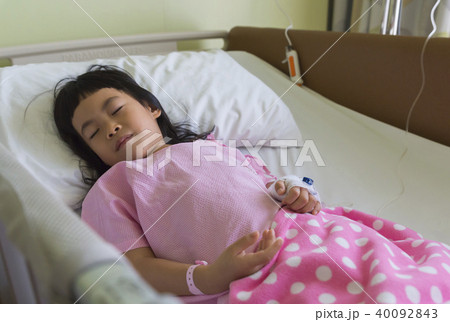 Asian child sleeping in hospital bed 40092843