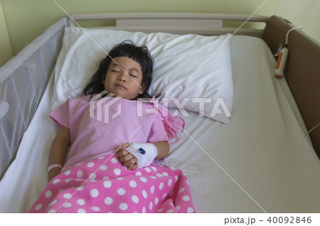 Child sleeping in hospital bed with equipment 40092846