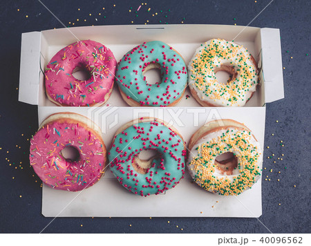 Donuts with colorful icing in box. Top view Donuts with colorful icing in box. Top view 40096562