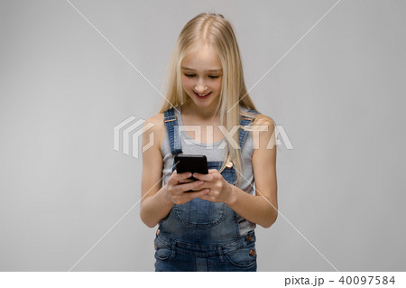 Young girl presenting telephone Young girl presenting telephone 40097584
