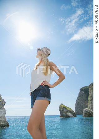 beautiful girl walking along the seashore in the summer day beautiful girl walking along the seashore in the summer day 40097653