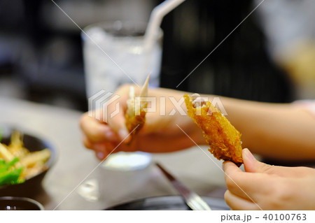 Hand holding bone of Roasted chicken leg Hand holding bone of Roasted chicken leg 40100763