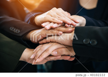 Business people making pile of hands for startup Business people making pile of hands for startup 40102222