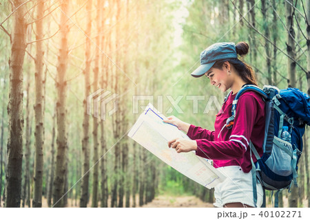 Female tourist travel in pine woods trip hiking 40102271