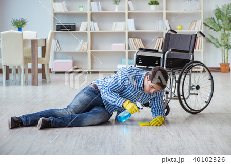 Disabled man on wheelchair cleaning home 40102326