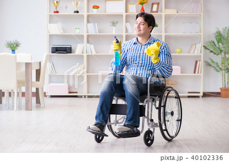 Disabled man on wheelchair cleaning home 40102336