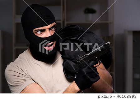 Burglar wearing balaclava mask at crime scene 40103895