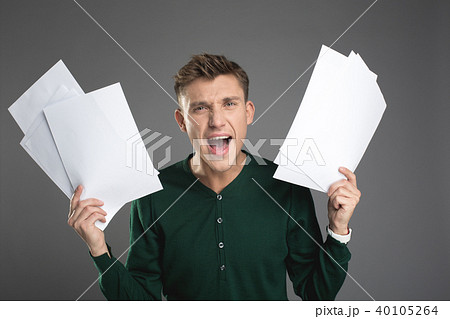 Screaming man showing lot of paperwork 40105264