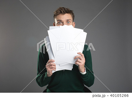 Dazed man hiding behind records 40105266