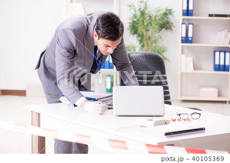 Forensics investigator at the scene of office crime Forensics investigator at the scene of office crime 40105369