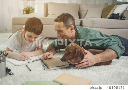 Happy father teaching boy maths at home 40106121
