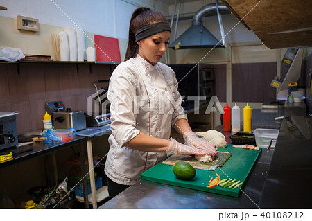 woman in white chef prepares sushi restaurant woman in white chef prepares sushi restaurant 40108212