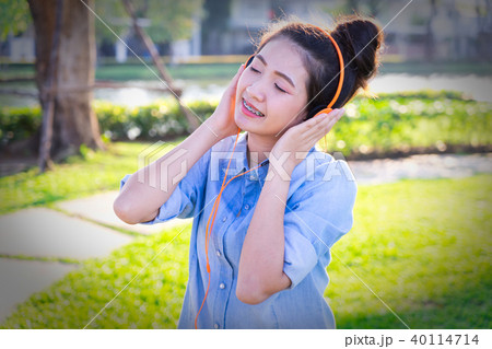 Young woman listening music with headphones. Young woman listening music with headphones. 40114714