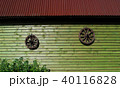 Two ancient wooden wheels on wall of wooden house 40116828