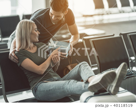 Outgoing man giving gift for smiling woman Outgoing man giving gift for smiling woman 40118519