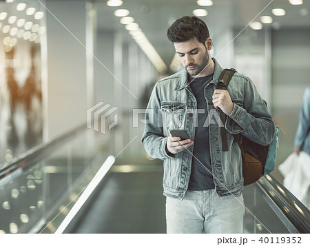 Orderly male using modern phone 40119352