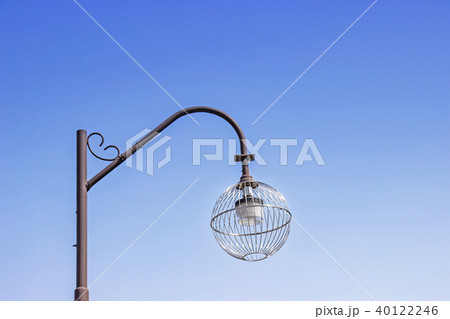 Modern circle shape street lamp against blue sky. Modern circle shape street lamp against blue sky. 40122246