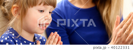 Cute little girl play with mom pat-a-cake Cute little girl play with mom pat-a-cake 40122331