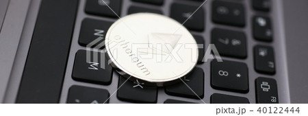 Silver ethereum coin is lying on laptop 40122444