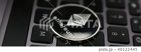Silver ethereum coin is lying on laptop 40122445