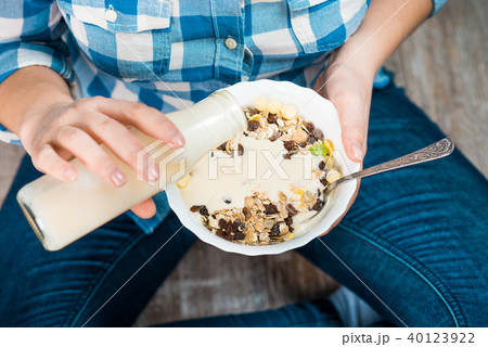 Girl with a plate of muesli Girl with a plate of muesli 40123922