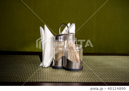 Pepper shaker, salt shaker and napkins on the stand 40124890