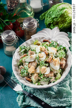 Caesar salad with cheese, eggs and croutons 40126897