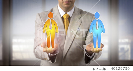 Manager Comparing Two Male Workers In His Hands 40129730